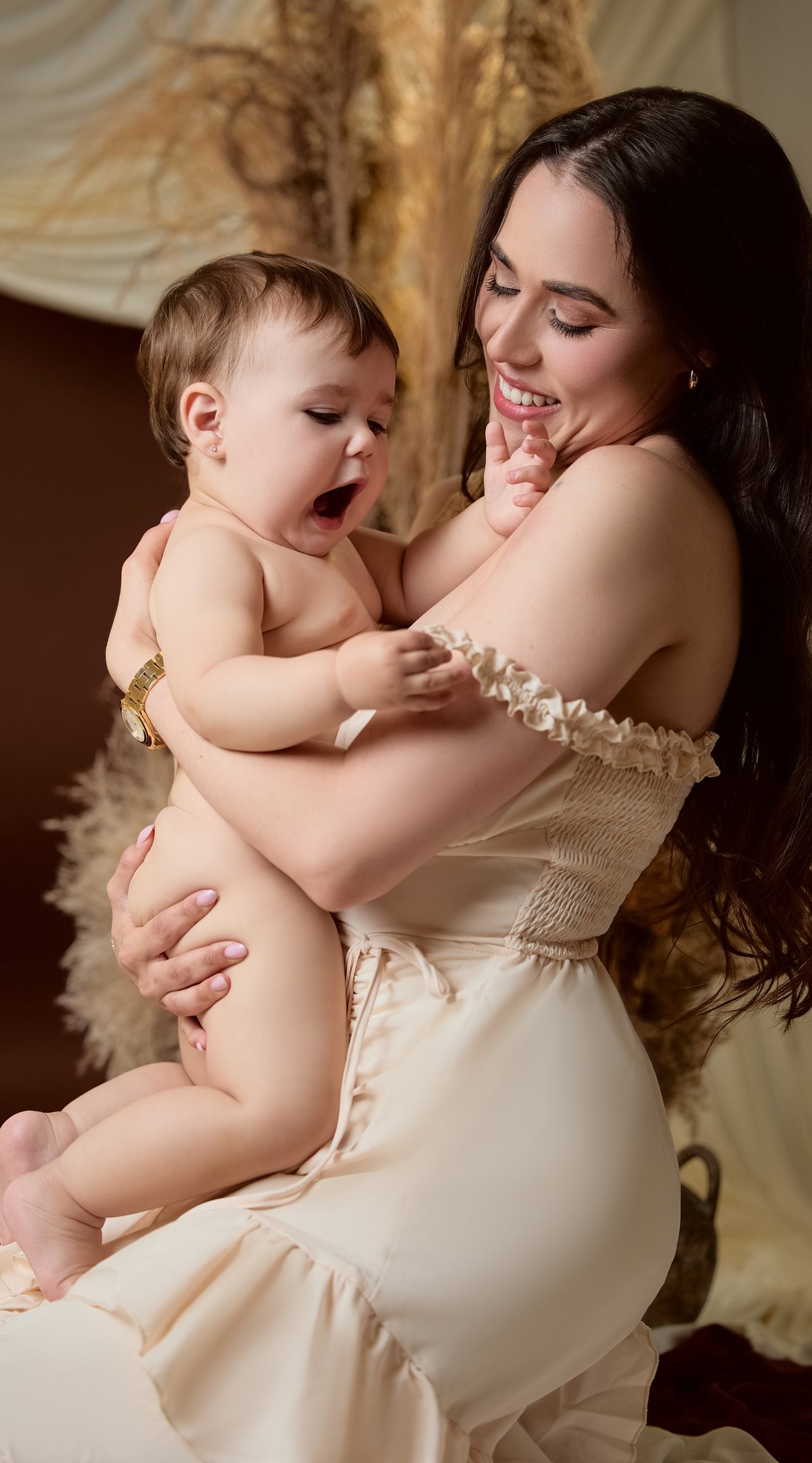 Mother holding her baby in studio